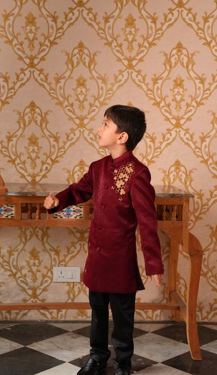 Boy wearing FunnyBones Maroon Achkan with Honeycomb Embroidery – maroon achkan with gold zari honeycomb and bees
