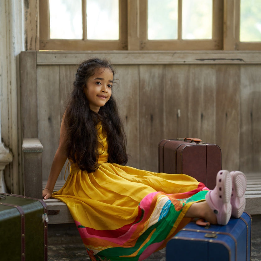 Indian girl wearing the Golden Savanna dress in Pure Satin Silk, Sunshine Yellow — FunnyBones.in Mehfil '26 festive collection.