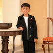Boy wearing FunnyBones Black Paint-Splash Jacket – black zip jacket with paint-splash embroidery