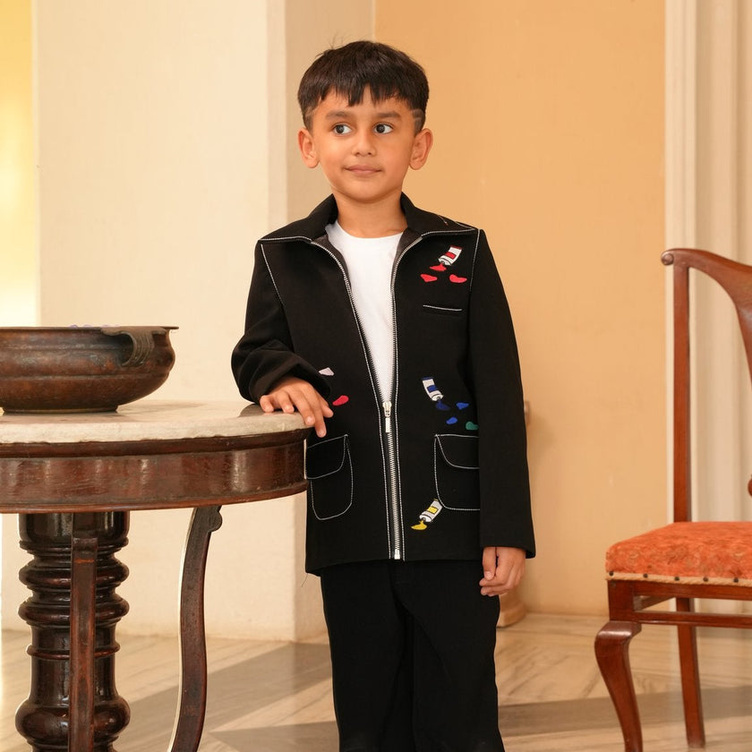 Boy wearing FunnyBones Black Paint-Splash Jacket – black zip jacket with paint-splash embroidery