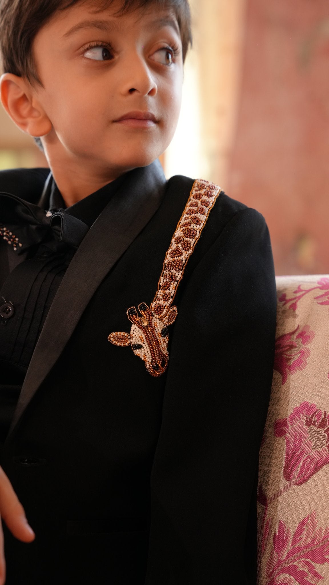 Boy wearing FunnyBones Black Tuxedo with Beaded Giraffe – black tuxedo blazer with hand-beaded giraffe on the lapel