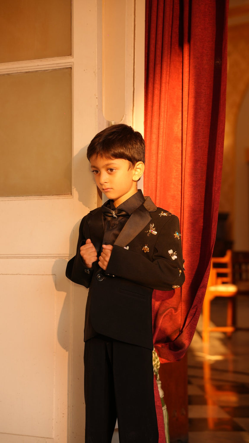 FunnyBones Black Tuxedo with Butterfly Bee – front view by a red curtain