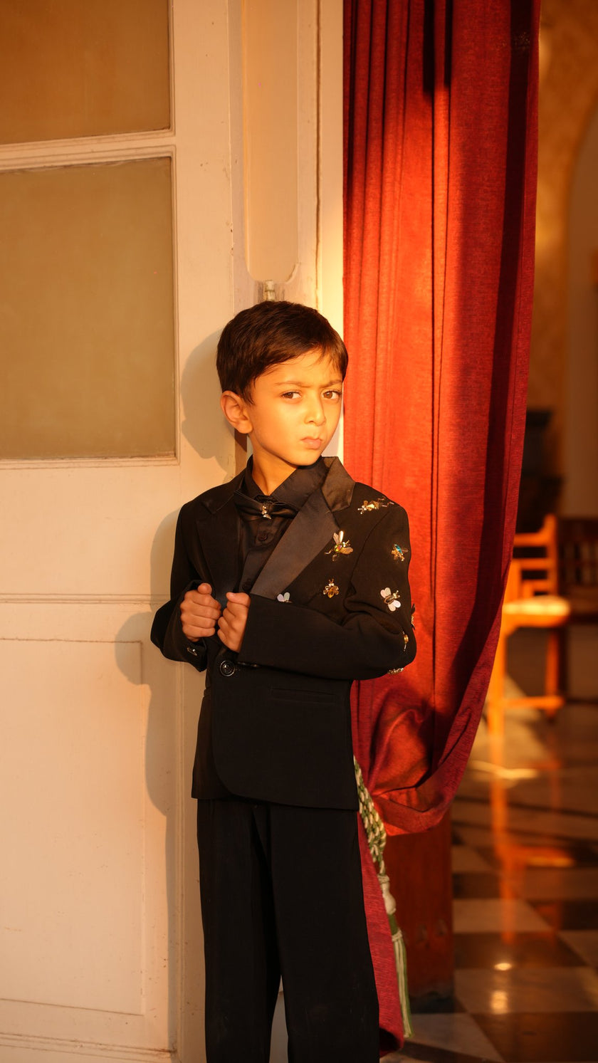 FunnyBones Black Tuxedo with Butterfly Bee – boy adjusting the lapel