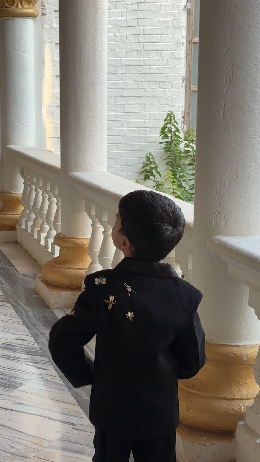 FunnyBones Black Tuxedo with Butterfly Bee – back view by the pillars