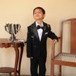 Boy wearing FunnyBones Black Tuxedo with Galaxy Embroidery – black tuxedo with bow tie for kids weddings