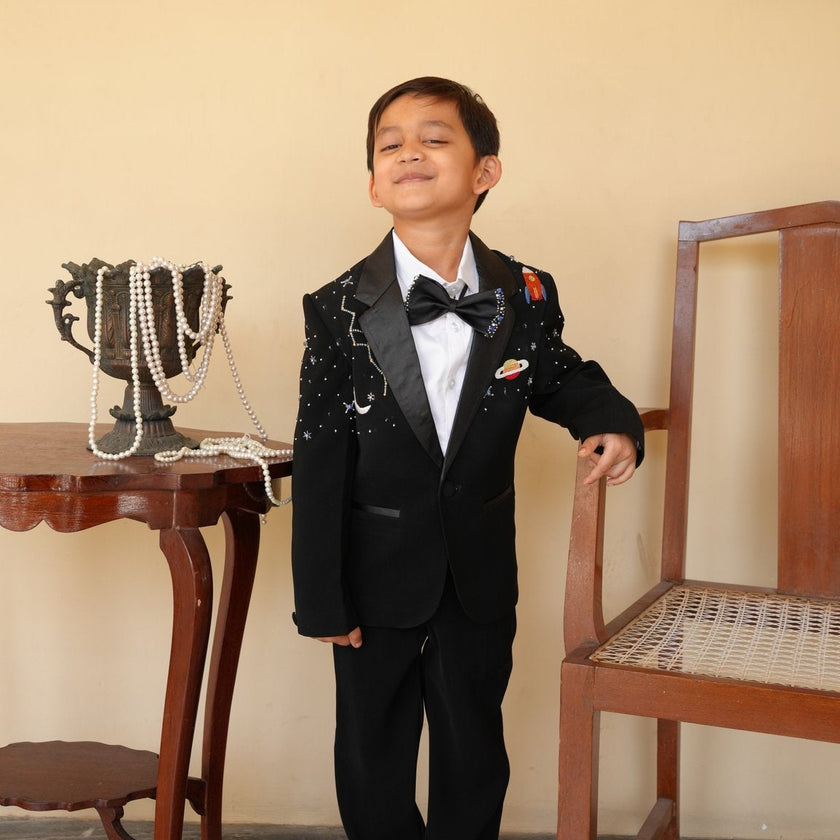 Boy wearing FunnyBones Black Tuxedo with Galaxy Embroidery – black tuxedo with bow tie for kids weddings