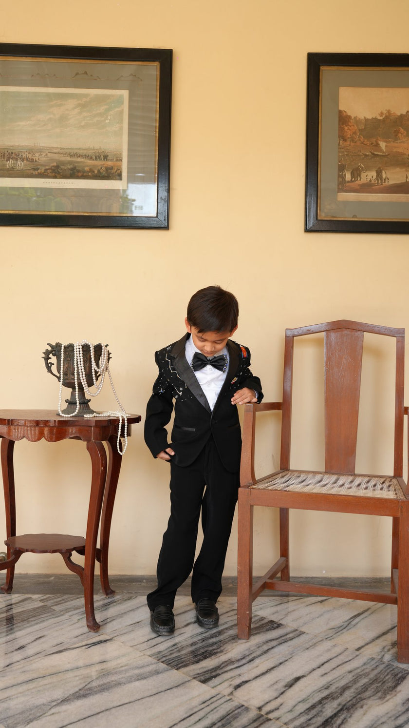 FunnyBones Black Tuxedo with Galaxy Embroidery – playful pose, kids party wear