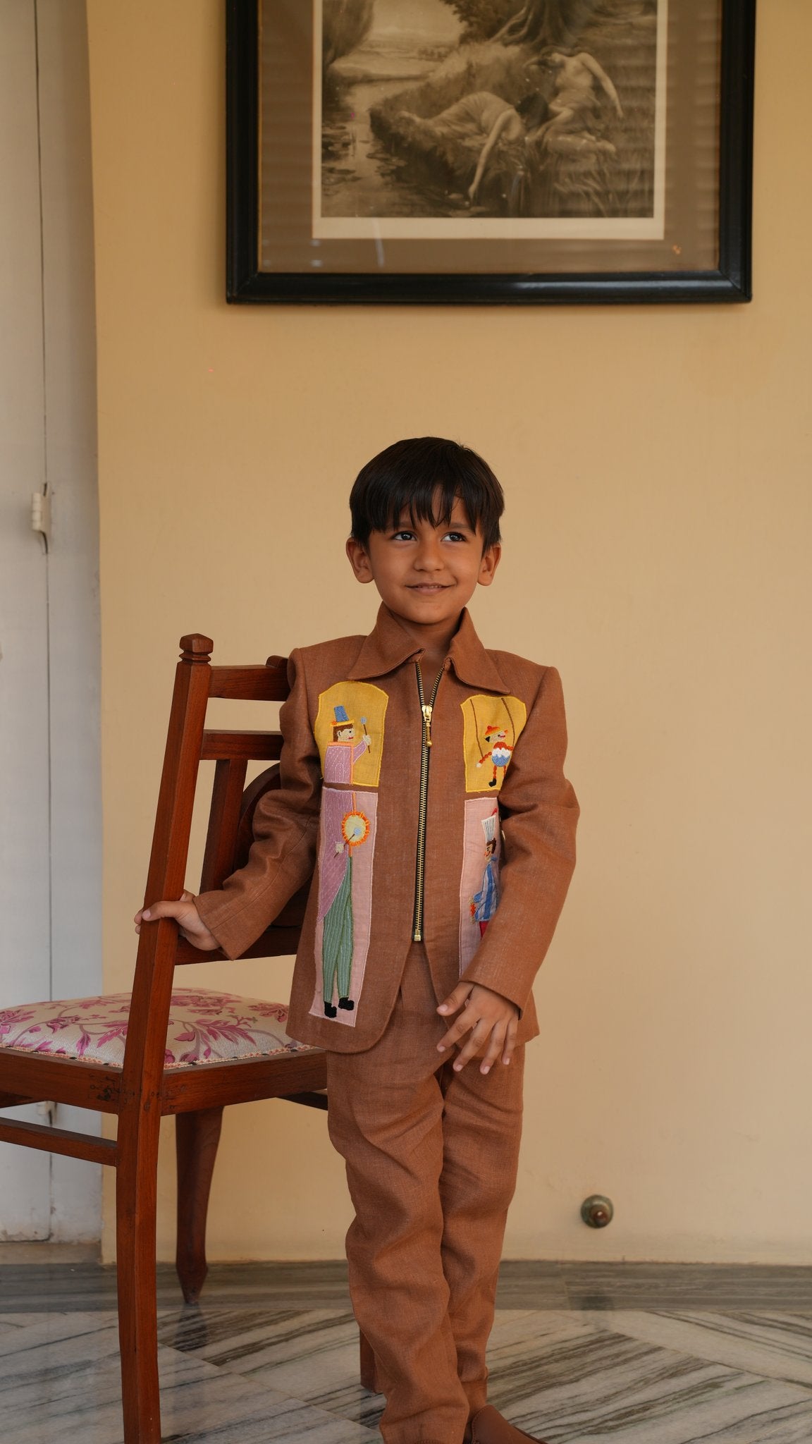 Boy wearing FunnyBones Circus Appliqué Zip Jacket – brown linen zip jacket with circus applique panels