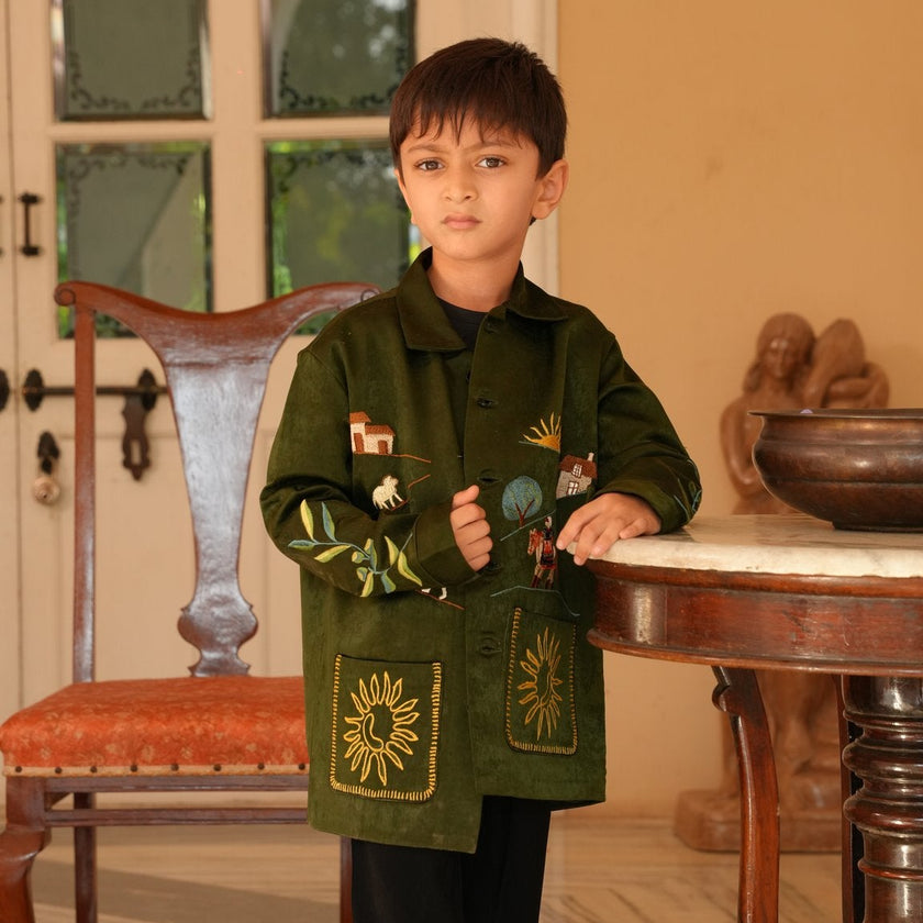 Boy wearing FunnyBones Farm & Paradise Appliqué Jacket – olive suede-look jacket with farm scene applique