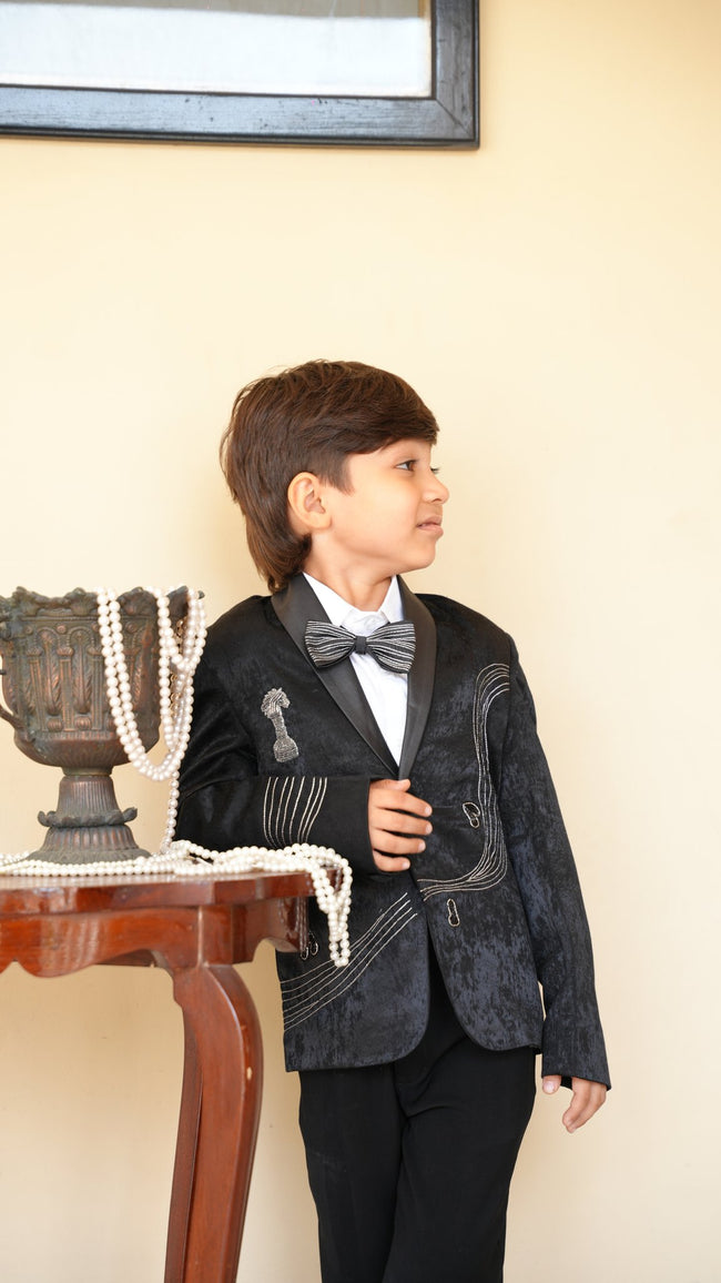 FunnyBones Grey Blazer with Music-Note Embroidery – boy posing by a side table