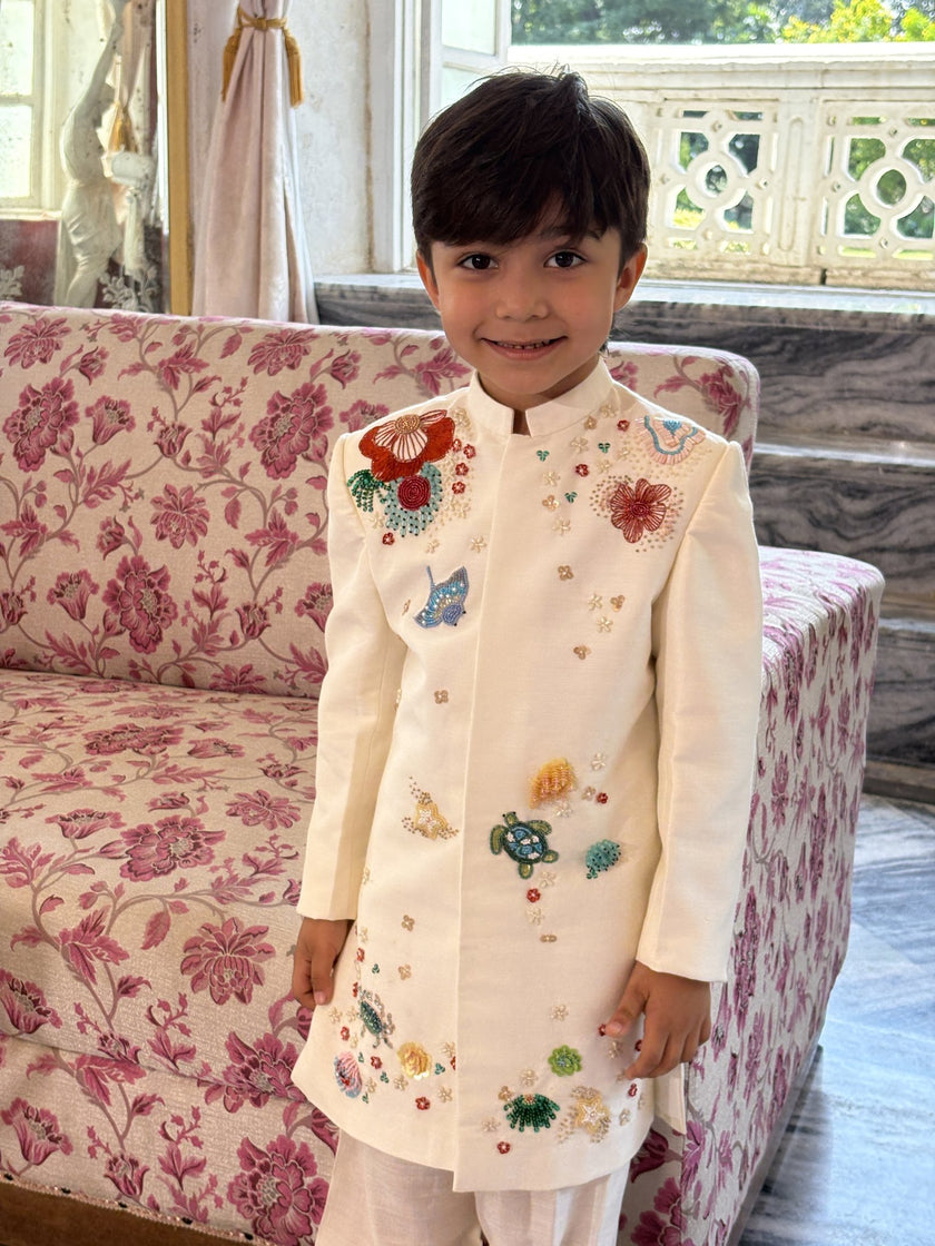Boy wearing FunnyBones Ivory Floral Embroidered Achkan Set – ivory achkan with multicolour bead and sequin florals