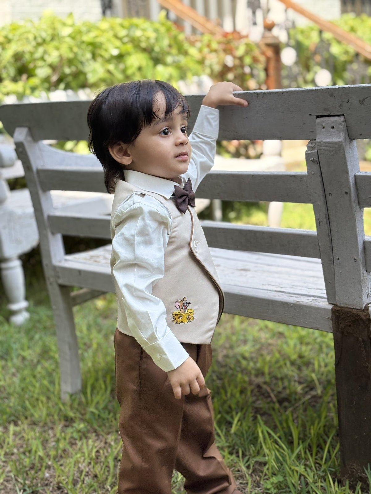 Boy wearing FunnyBones Ivory Wrap Waistcoat with Cartoon Appliqué – ivory wrap waistcoat with cartoon applique and brown pants