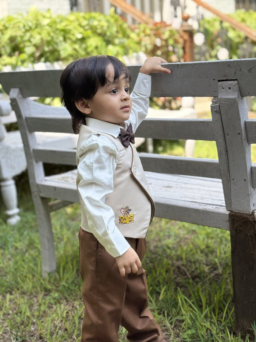 Boy wearing FunnyBones Ivory Wrap Waistcoat with Cartoon Appliqué – ivory wrap waistcoat with cartoon applique and brown pants