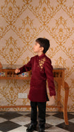 Boy wearing FunnyBones Maroon Achkan with Honeycomb Embroidery – maroon achkan with gold zari honeycomb and bees