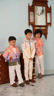 Three boys in FunnyBones wedding wear, centre boy in the ivory pastel appliqué zipper jacket and ivory pants