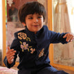 Boy wearing FunnyBones Navy Jodhpuri with Floral & Crane Embroidery – navy jodhpuri with bead rose and zari crane embroidery