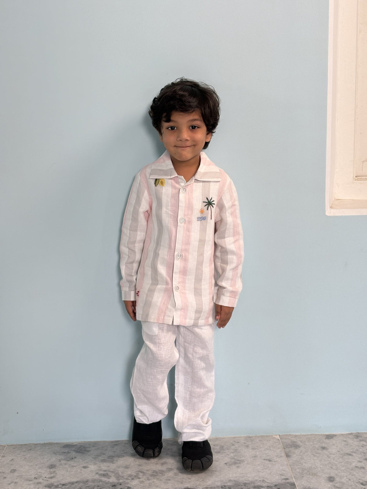 Boy wearing FunnyBones Seaside Stripe Shirt – pastel stripe linen shirt with seaside embroidery