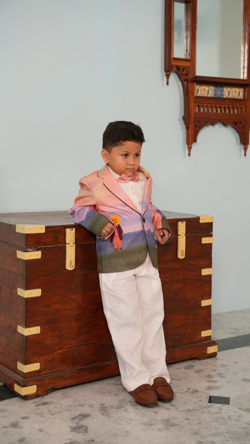FunnyBones Sunset Storybook Blazer – boy leaning on a vintage trunk