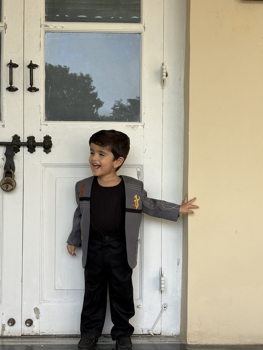 Boy wearing FunnyBones White Blazer with Animal Panels – grey panel blazer with giraffe embroidery and black tee
